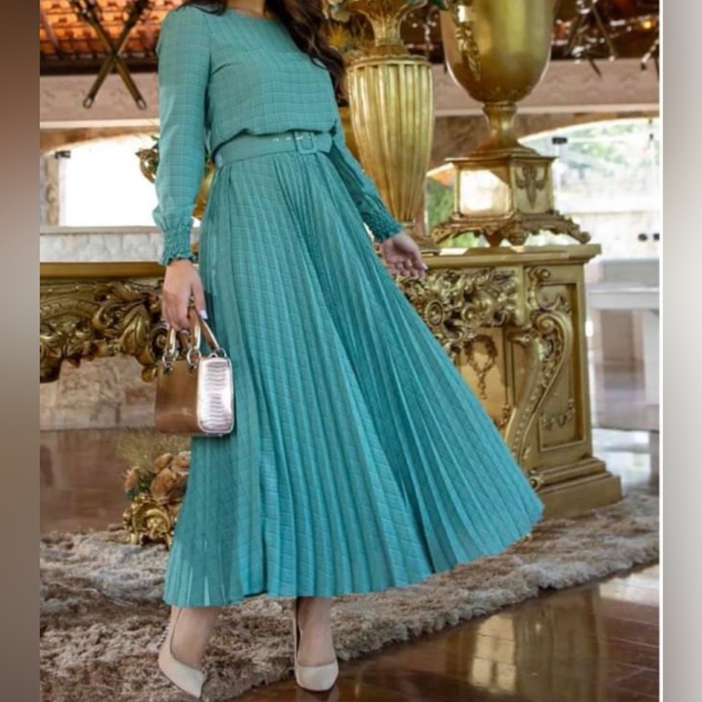 Green dress with pleated skirt.